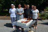 Pani Dyrektor, Ksiądz Tadeusz, Pracownicy naszego Domu oraz kremowy tort.